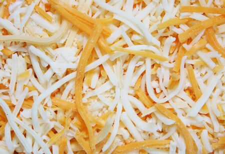 A background of shredded cheddar and montery jack cheeseの写真素材