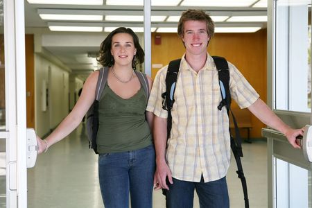 Two students (Man and woman) leaving school after obtaining an educationの写真素材