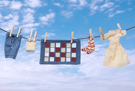 Several pieces of laundry drying on a clothes line over white