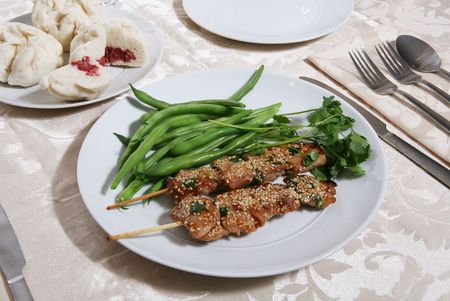 Chicken dinner with vegetables and other side dishesの写真素材