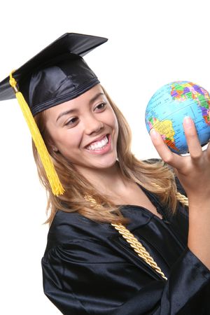 A pretty woman graduate holding a small globeの写真素材