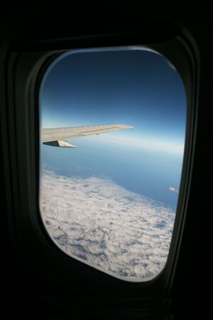 A view out the window of an airplane above the clouds