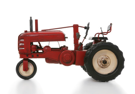 An old vintage tractor isolated over whiteの写真素材