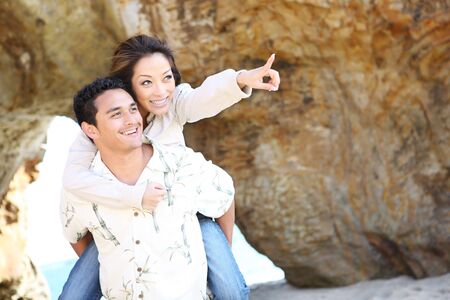 An attractive couple having fun at the beachの写真素材