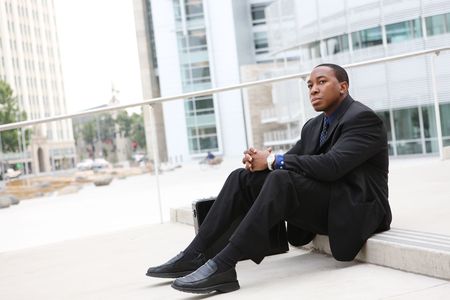 A handsome African Business Man Sitting at Office Buildingの写真素材