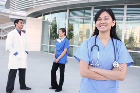 A happy and successful medical team outside hospital buildingの写真素材