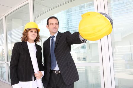 Man and woman architects on a building construction siteの写真素材