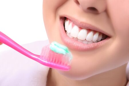 A close-up of a beautiful woman brushing her teeth