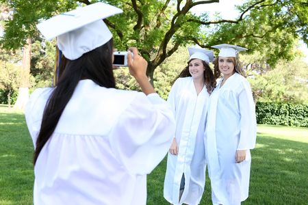 Pretty young women at graduation taking a picture