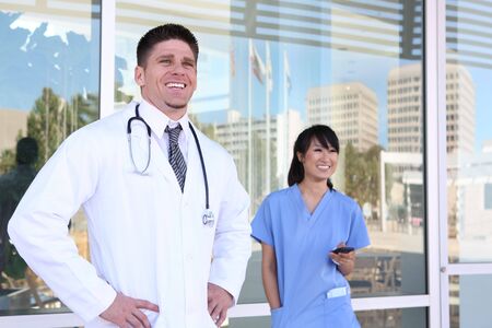 A handsome male doctor outside his medical officeの写真素材