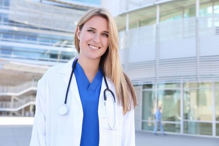 A pretty young blonde woman nurse outside hospitalの写真素材