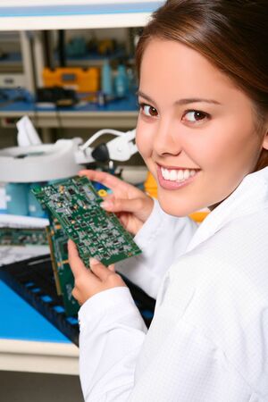 Pretty women technician working on computer parts in the labの写真素材