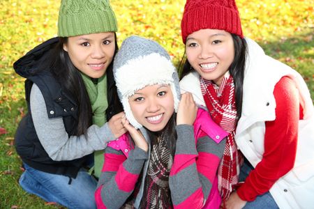 Pretty young asian girls in the park during autumn