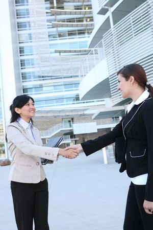 A beautiful young business woman shaking hands with colleagueの写真素材