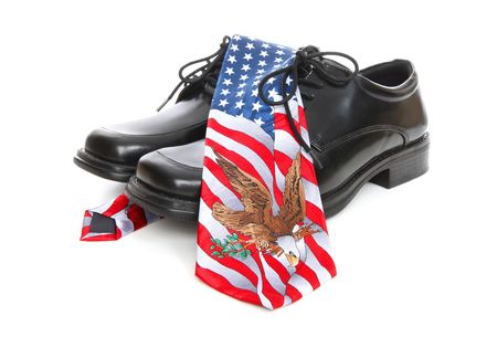 A business man's shoes and a usa (america) theme  tie over white backgroundの写真素材