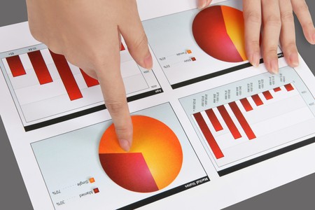 A woman pointing at a colorful chart graph