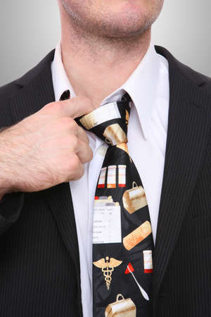 A doctor man feeling stress while pulling his shirtの写真素材