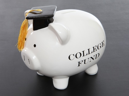 A piggy bank to act as a college fund over black backgroundの写真素材