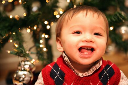A cute baby boy smiling at Christmasの写真素材