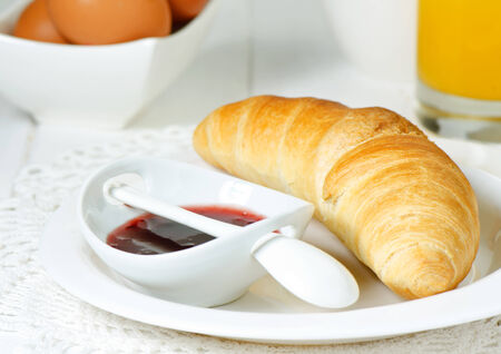 Breakfast with croissant, jam and orange juiceの写真素材