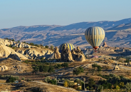 Balloons flight over the eroded landscape in Cappadocia, Turkeyのeditorial素材