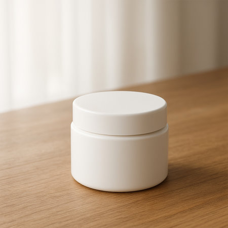Premium white cream jar mockup on a natural wooden table, well-lit, showcasing clean, minimal, and elegant skincare packaging design.の素材