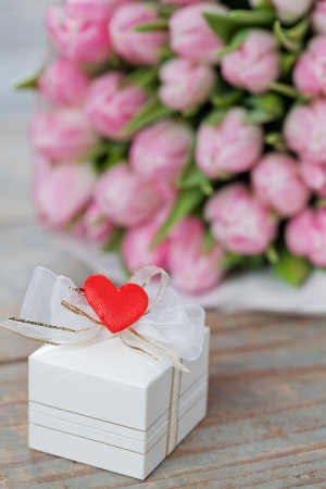 Valentine gift box decorated with heart, tulips on backgroundの写真素材
