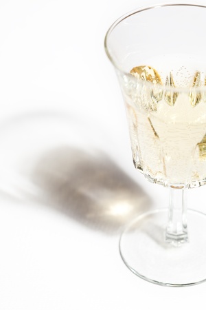 Glass of white wine with shadow on whiteの写真素材