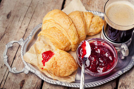 Coffee and croissants on tray on wooden backgroundの写真素材