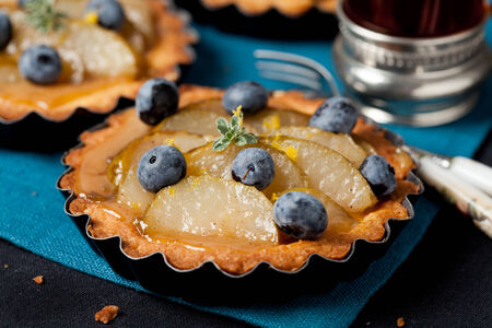 Homemade pear and blueberry tartsの写真素材