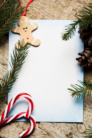 Christmas decoration with blank paper on wooden backgroundの写真素材