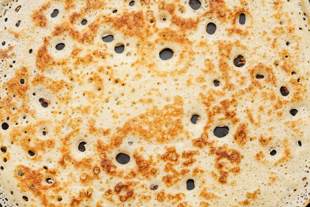 Closeup of yeast pancake, traditional for Russian pancake week, background