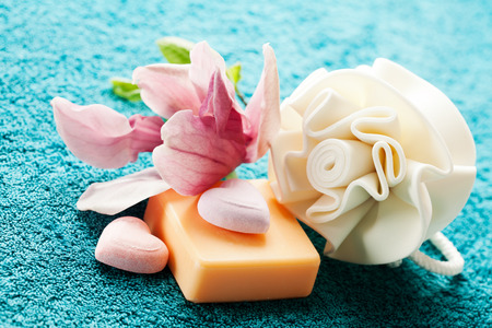 Spa setting with bath salt  and bath accessories on blue towelの写真素材