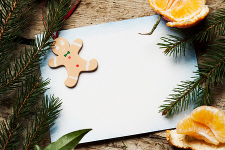 Christmas decoration with blank paper on wooden backgroundの写真素材