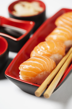 Salmon nigiri sushi on plate with chopsticksの写真素材