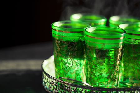 Oriental mint tea in traditional green glassesの写真素材