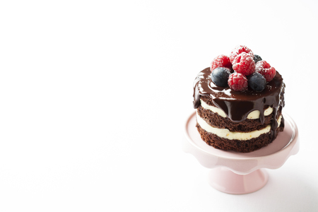 Tiny chocolate naked cake with fresh berriesの写真素材