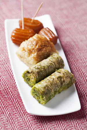 Variety of oriental sweets with cup of coffeeの写真素材