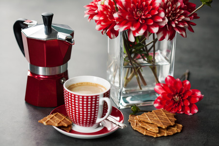 Cup of coffee with  coffee maker and flowersの写真素材
