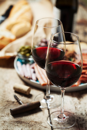 Red wine with charcuterie assortment on the backgroundの写真素材