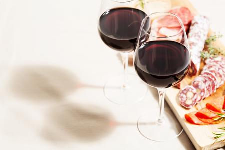 Red wine and charcuterie assortment on the boardの写真素材
