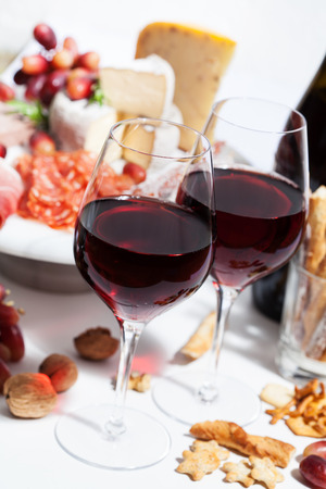 Red wine and charcuterie assortment on the boardの写真素材