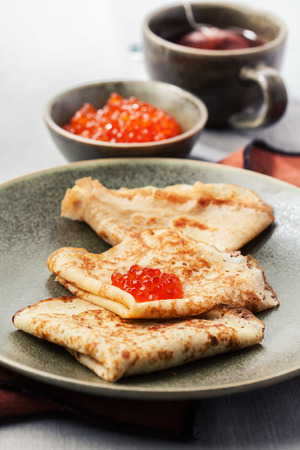 Sourdough pancakes with red salmon caviar traditional for Russian pancake weekの写真素材