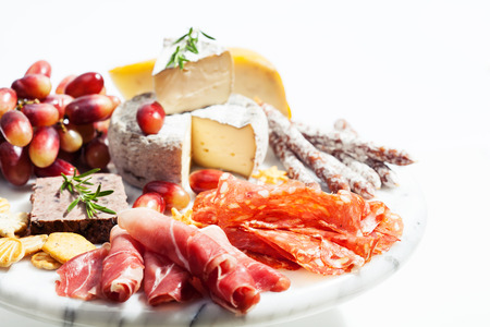 Food tray with charcuterie assortment, cheese  and grapesの写真素材