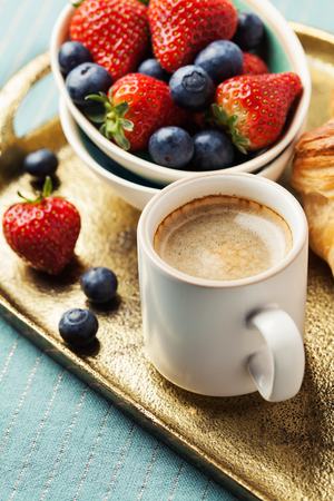 Breakfast setting with coffee, berries  and croissantの写真素材