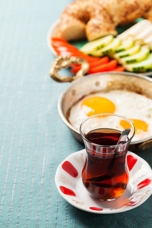 Traditional Turkish breakfast with fried eggs and tea. Travel conceptの写真素材