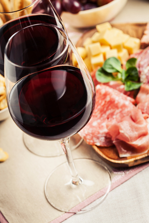 Red wine with charcuterie, cheese, grapes and snacksの写真素材