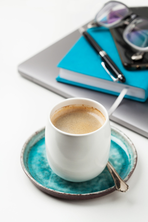 Cup of coffee with buisiness accessories on the backgroundの写真素材