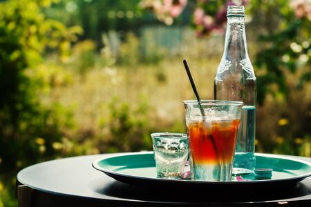 Iced coffee tonic cocktail on table outsideの写真素材