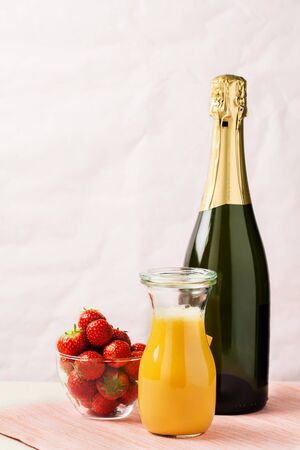 Two glasses of mimosa cocktail (champagne with orange juice) and fresh strawberriesの写真素材